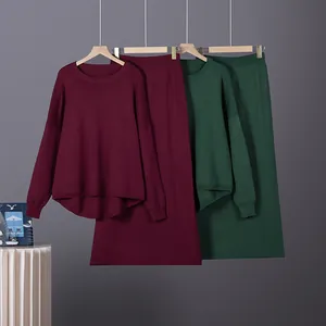 Elegant two-piece knit set with long-sleeve sweater and matching skirt in burgundy and green.