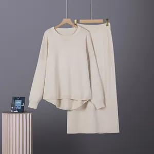 Detailed view of cream minimalist two-piece knit sweater and skirt set on hangers