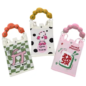Cute INS style mini handbag featuring padded curved handles and colorful embroidery detail