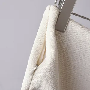 Close-up detail of a white knit skirt featuring a high-quality concealed zipper.