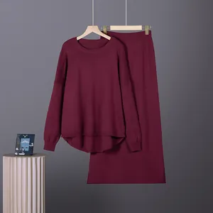 Detail view of burgundy two-piece knit sweater and long skirt set with a high-low hem design