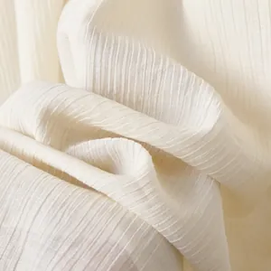 Detailed macro view showing the soft cream-colored ribbed knit fabric texture of this outfit