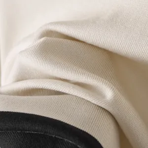 Detalle macro de tejido de punto blanco roto de alta calidad con ribete negro