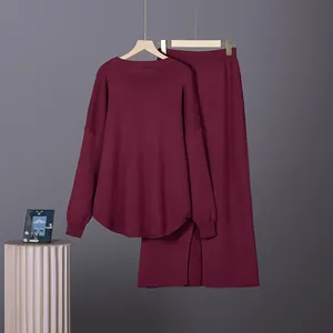 Detailed view of burgundy two-piece knitwear set with long sleeve sweater and skirt