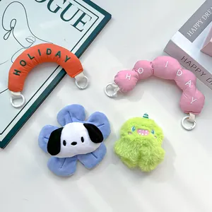 Detailed view of colorful plush handbag straps with holiday embroidery and cute charms