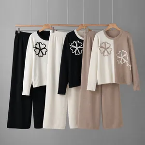 Three color variants of two-piece knit set with flower embroidery