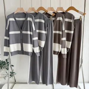 Detailed shot of stylish women's three-piece striped knit set including cardigan and pants