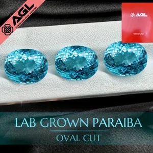 Dettaglio di tre pietre preziose Paraiba coltivate in laboratorio con taglio ovale su base