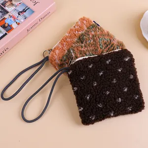 Close-up detail of soft lambswool plush pouches featuring durable cord straps and zippers