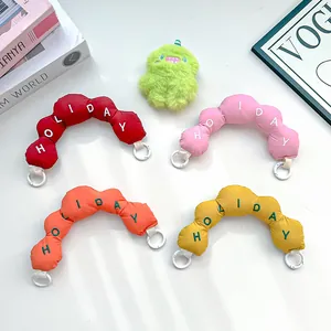 Colorful padded bag handles with HOLIDAY embroidery and white ring clips displayed