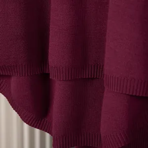 Detailed macro view of high-quality wine red knit sweater fabric with ribbed hem finish