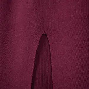 Detail view showing the fine-knit texture and slit design on a burgundy autumn sweater.