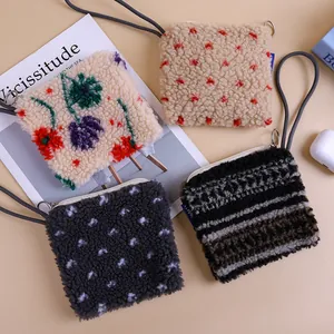 Set of plush lamb wool mini coin purses in various floral and polka dot patterns.