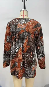 Detailed back view of a loose-fitting long-sleeve top with vintage paisley patterns