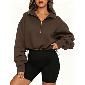 Detailed view of women's brown half-zip cropped sweatshirt with drawstring waist detail