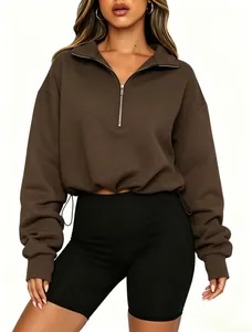 Detailed view of brown half-zip cropped sweatshirt with drawstring waist and collar