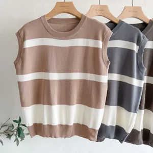 Close-up detail of three striped knit vests in brown, grey and coffee tones