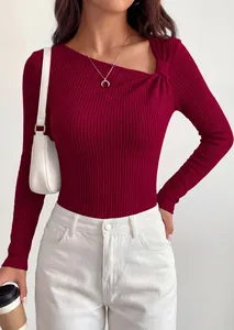 Detailed close-up of burgundy asymmetrical neck knit top with stylish rib texture design