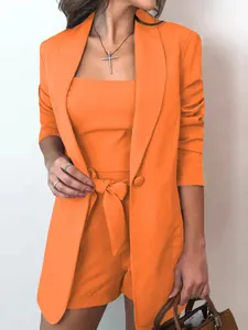 Stylish vibrant orange 3-piece women's suit set including blazer, tank top, and shorts.