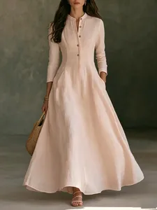 Detail of elegant French vintage linen maxi dress with mandarin collar and full skirt