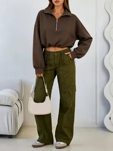 Detailed view of cropped brown half-zip sweatshirt with drawstring waist and cargo pants