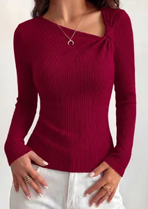 Detail view of burgundy asymmetric neck ribbed knit top with shoulder knot detail.