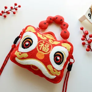 Close-up of a red plush lion dance handbag with Fu character embroidery.