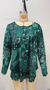 Close-up of green paisley print long-sleeved top with button details