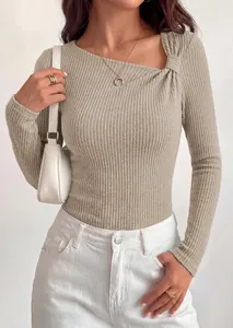 Detailed view of women's ribbed knit top with asymmetrical slant neck and twist knot feature