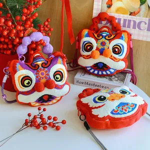 Detailed view of three colorful lion dance plush bags with intricate embroidery