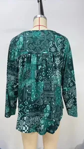 Back view of women's loose long-sleeved top with detailed paisley pattern
