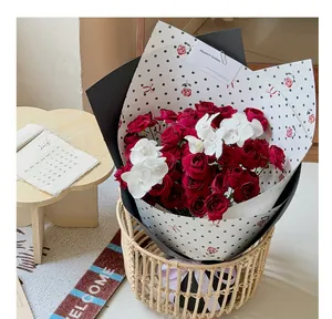 Elegant polka dot wrapping paper with rose pattern shown in a floral bouquet arrangement