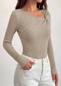 Detail view of the asymmetrical knot neckline and ribbed knit texture of a tan top.