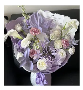 Handmade textured Eastba paper used for wrapping a purple and white flower bouquet