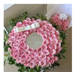 Detailed view of a circular pink rose floral arrangement with a central mirror and Love You text