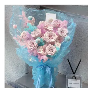 Close-up of dreamy light blue glass gauze mesh wrapping a romantic pink rose bouquet