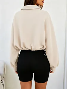 Back view of beige half-zip cropped sweatshirt with adjustable drawstring hem.