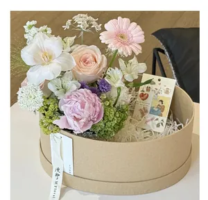 Elegant oval kraft paper gift box featuring a beautiful forest-style floral arrangement.