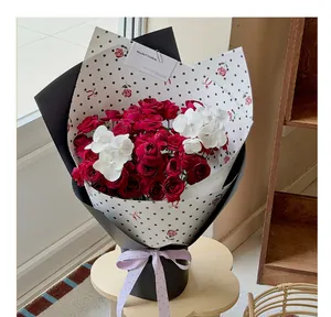 Detailed view of polka dot wrapping paper used for a red rose bouquet arrangement