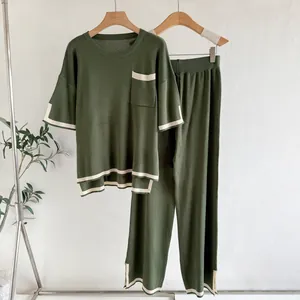 Detailed macro view of olive green knit two-piece set with cream contrast stripes