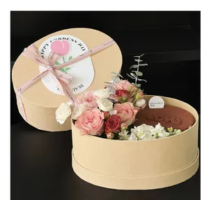 Detailed view of an oval kraft paper gift box featuring fresh roses and a chocolate cake