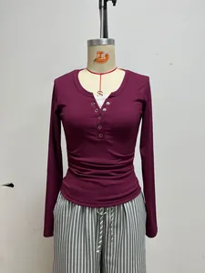 Detailed shot of a slim fit burgundy long sleeve knit top featuring sexy lace trim details.
