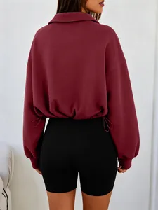 Back view of burgundy cropped sweatshirt featuring adjustable drawstring waist and collar