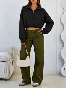 Detail showing black half-zip cropped sweatshirt with adjustable drawstring waist.