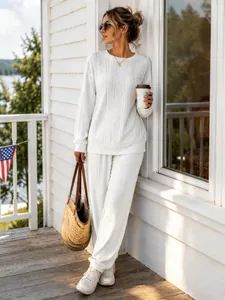 Fashionable white cable-knit two-piece lounge set featuring cuffed pants and round neck top