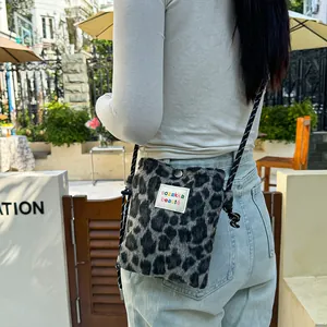 Stylish leopard print plush crossbody bag with colorful logo label and rope strap