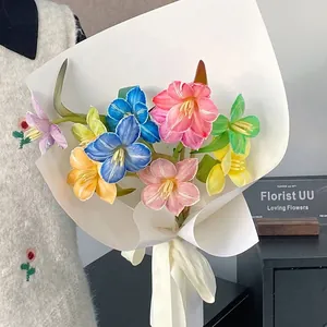 Vibrant multi-colored flower bouquet treated with absorbent flower dye in white wrapping