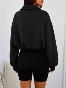 Detailed back view of a black half-zip cropped sweatshirt featuring a drawstring waist