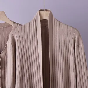 Detailed macro view of taupe ribbed knit cardigan showing soft fabric texture and collar