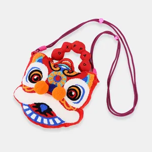 Detailed view of cute plush crossbody bag with traditional lion dance embroidery design.